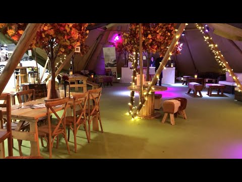 The National Wedding Show - 2 giant tipis, all sides raised, bar & casual arrangement